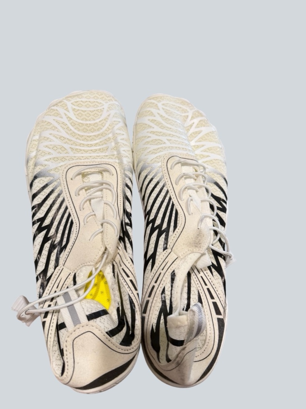 Graphic White Athletic Sneakers with Black Stripes and Yellow Detail